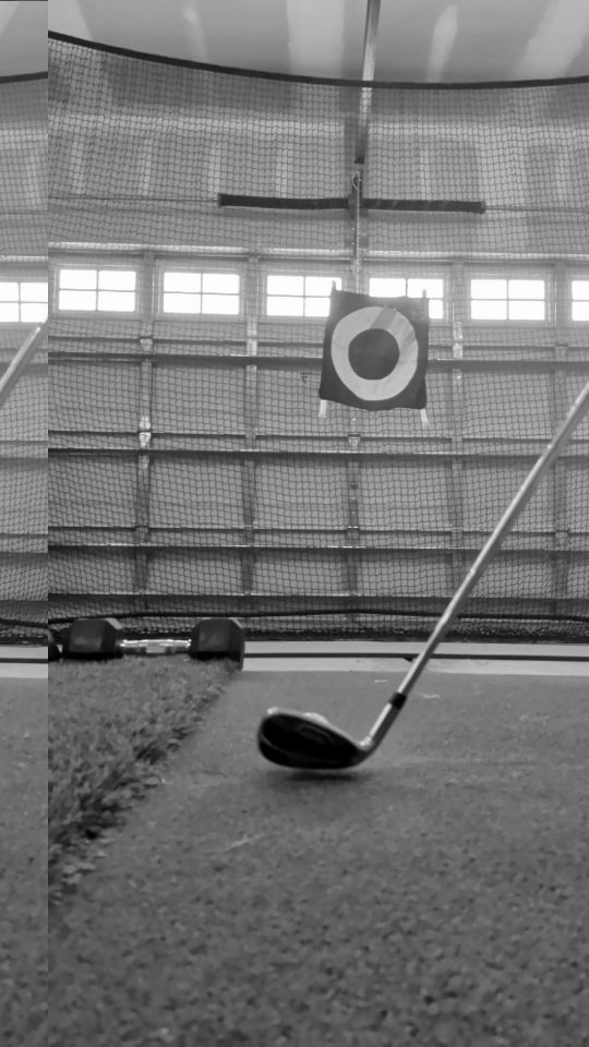 A club head set down behind a golf ball at the lie, an action that can fool a naive swing trigger